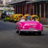 A vintage car passes Floridita restaurant in Old Havana.