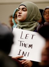 A protester demonstrates against President Donald Trump's travel ban barring citizens of seven predominantly Muslim nations entry into the US at Dallas/Fort Worth.
