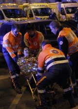 An injured woman is rescued near Le Bataclan.