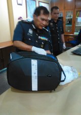 Director of Customs at Malaysia's international airport shows the bag allegedly containing drugs that was being carried by Maria Elvira Pinto Exposto when she was arrested.