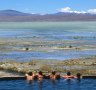 Tourists relax in the thermal pools in the Bolivian Altiplano.