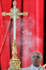 Pope Francis asperges incense on the altar as he celebrates the Mass.