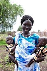 Nyabang Lul, 23, brings her twin daughters Nyajuok and Nyatut, right,   to be screened for malnutrition at The Save the Children feeding centre in Denjuok, South Sudan, last year.