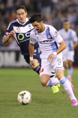 City's star player David Villa is tracked by Victory's skipper Mark Milligan.