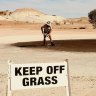 A local rakes out the green at the Coober Pedy Golf Course.