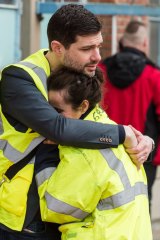 People comfort one another outside Brussels airport.