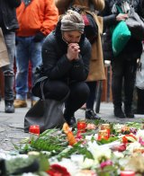 People lay flowers near where a lorry ploughed through a Christmas market in Berlin.