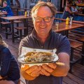 Dean Oberin holds a local yabby po' boy at his outdoor bar Harry O's in Echuca, Victoria. 