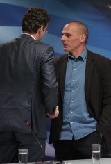 Dutch Finance Minister and Eurogroup President Jeroen Dijsselbloem, left, talks to Greece's Finance Minister Yanis Varoufakis after their meeting at the Finance Ministry in Athens.