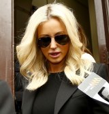 Oliver Curtis' wife Roxy Jacenko leaves court after her husband was sentenced to two years in prison, to be released after one year.