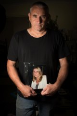 Jamie Hare holding a picture of his partner Linda who died in 2010.