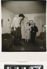Diane Arbus, A Jewish giant at home with his parents in the Bronx, NY, 1970.