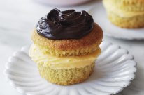 Boston cream cupcakes sandwiched with whipped coconut custard.