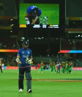 Instant replay:  James Anderson trudges off as his dismissal in shown on the big screen at the Adelaide Oval.