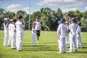Burgmann Anglican School and Eastlake players spin the bat in their first game after the death of Australian Batsman Phillip Hughes. 