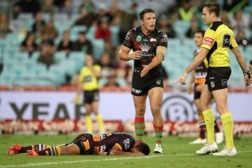 Floored: Anthony Milford lies injured on the ground as Sam Burgess appeals to the referee. A moment later Milford kicked a penalty goal.