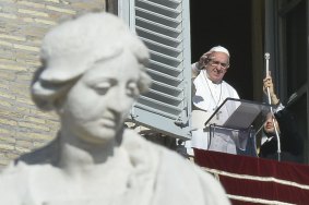 Pope Francis greets the crowd from the window overlooking St Peter's square. 