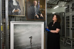 Art collection manager Justine van Mourik pulls out a shelf with Jiawei Shen's study of John Howard for his official portrait as well as a Michael Cook work. 