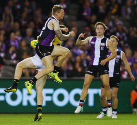 Tim Membrey of the Saints hits Dylan Grimes of the Tigers.