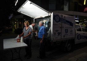 Vinnies Night Patrol van team leaders Therese Edwards, front, and,  back from left, Brian Kinnane and Peter Kinnane set up near Garema Place in Civic.