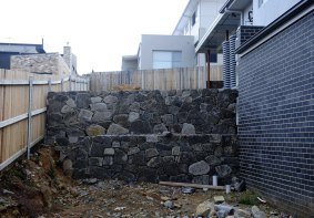 Property owners at this site had to dig the garage in under the house and build a retaining wall to comply with solar access provisions.