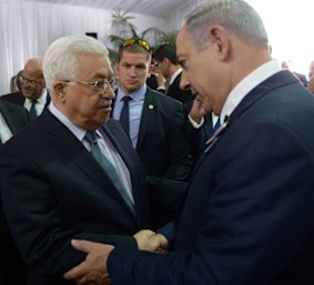 Israeli Prime Minister Benjamin Netanyahu shakes hands with Palestinian President Mahmoud Abbas Shimon Pere' funeral. 