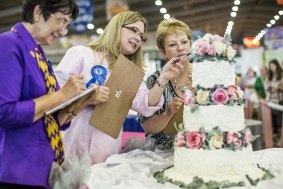 Sweet art: Judges in the esteemed Grand National Wedding Cake Competition check out an entry. 