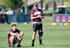Hopeful: Nate Myles wears a knee brace with Billy Slater sitting beside him during a Queensland Maroons State of Origin training session at Sanctuary Cove on Thursday.