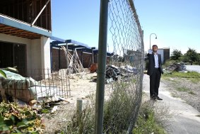 Goran Josifovski in front of one of the 11 vacant blocks. This site, opposite a park, is not secured and has building material blocking the footpath.  