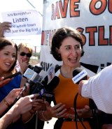 Minister for Transport and Minister for the Hunter Gladys Berejiklian is surrounded by activists while making a transport announcement in Newcastle.