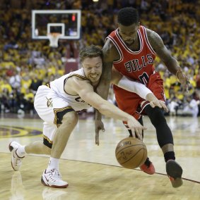 Scratching and clawing: Cleveland Cavaliers guard Matthew Dellavedova scrambles for a loose ball against Chicago Bulls opponent Aaron Brooks.