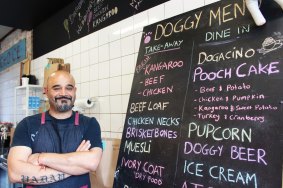 Anuj Yadav with the menu at the Doghouse Cafe. 