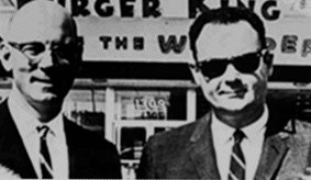 David Edgerton, right, with his Burger King partner, James W. McLamore in front of a Burger King store. 