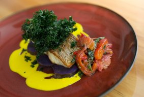 Fried barramundi with kale.