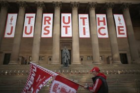 A banner reading Truth and Justice is hung from the Doric pillars of Saint George's Hall in the centre of Liverpool.