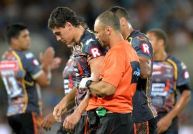 Assisted from the field: Indigenous All Stars forward Kyle Turner is taken off by medical staff after being hit high in a tackle by Paul Gallen during the NRL All Stars pre-season match at Cbus Super Stadium in February.