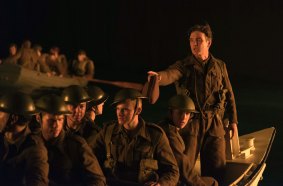 Cillian Murphy, standing, in a scene from Dunkirk.