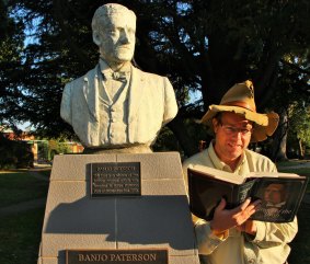Tim reads some of Banjo's poetry at his statue in Banjo Paterson Park, Yass. 
