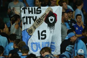 Provocative: A Sydney FC fan holds up a banner.