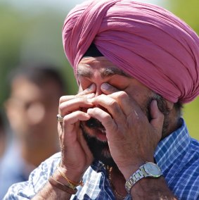 A man reacts outside the Sikh Temple of Wisconsin in Oak Creek, where a shooting took place in August 2012. 