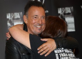 The Boss hugs a fan at a signing for his book <i>Born to Run</i> in London last year. 