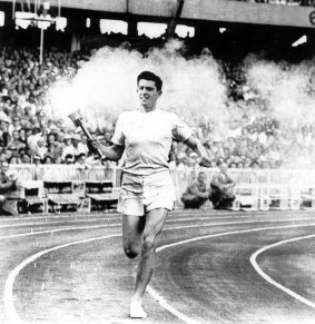Olyspecial. Melbourne Olympics. Ron Clarke carries the flame around the arena during the opening ceremony. Fairfax Archives. 25 November 1956.