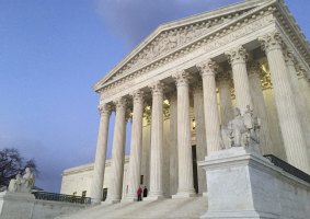 People stand on the steps of the Supreme Court at sunset after the US Marshals Service confirmed that Justice Antonin Scalia died at the age of 79. 