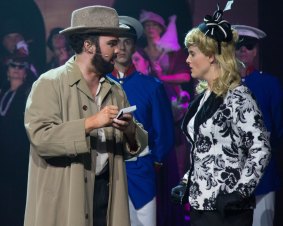 Grant Pegg as Che the interviewer and Kelly Roberts as Eva Peron in Canberra Philharmonic's production of Evita. 