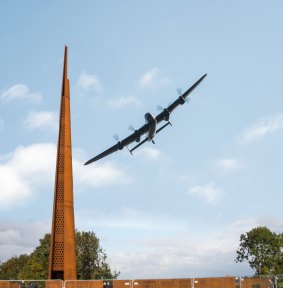 Lancaster bomber flying past International Bomber Command Centre.