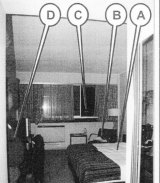 The police photograph of the Southern Sun hotel room: Roebuck was sitting in the chair marked B, a policeman was standing at the spot marked D.
