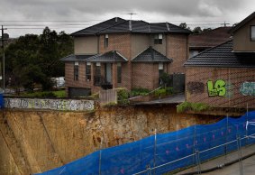 Only tufts of grass still clung to the edges of the townhouse after the collapse.