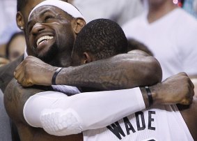 LeBron James and Dwyane Wade celebrate Miami's 2012 NBA championship win.