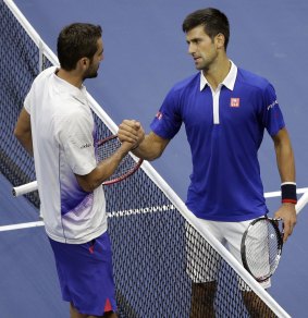 Sorry about that flogging: Novak Djokovic greets Marin Cilic after winning in straight sets.