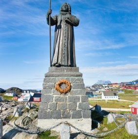 A statue of Hans Egede  on the top of seaside hill overlooking Nuuk.